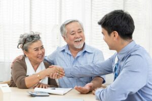 happy-senior-couple-handshaking-with-real-estate-agent